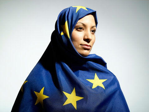 Woman in blue headscarf made of a European flag against a light background