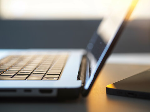laptop computer with sunlight coming through window