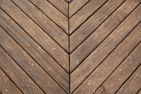 Symmetrical chevron design of weathered wooden planks with a clear central dividing line, Auckland, New Zealand