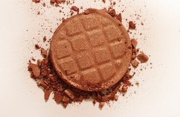 Broken bronzer powder compact close-up