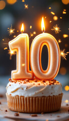 Celebratory cupcake with sparkling number 10 candle for milestone birthday or anniversary