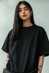 Fototapeta premium Stylish mockup of a plain black oversized t-shirt on a young woman, ideal for branding and design