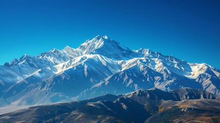 Obraz premium A snowy mountain range against a clear blue sky.