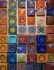 Generated image A variety of intricately designed Moroccan tiles and ceramics, displayed in a souk