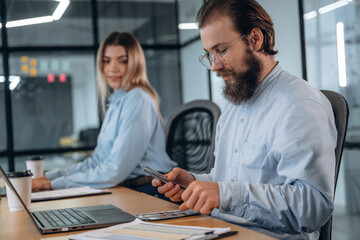 Counting money. Man and woman are in the office together