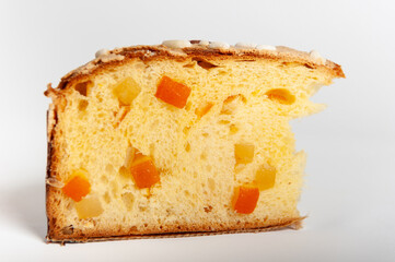 Slice of Panettone fruit cake with diced fruit pieces