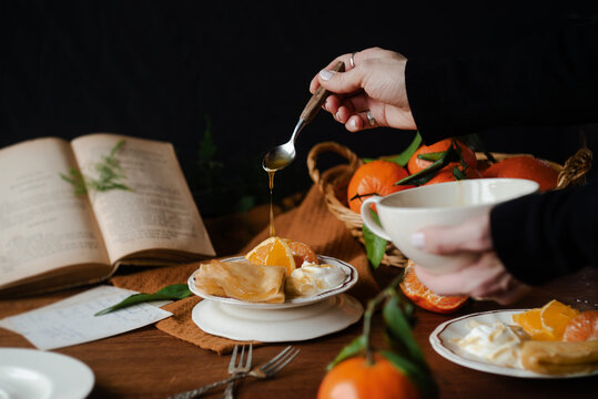 Serving citric crepes with yogurt and fresh oranges
