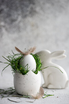 Elegant Easter egg with grass nest and ceramic bunny