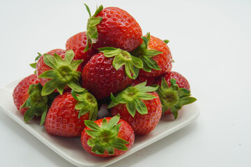 pile of fresh strawberries on a plate