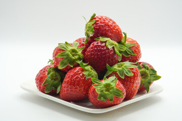 pile of fresh strawberries on a plate