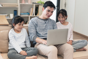 Young Asian father and daughter at home