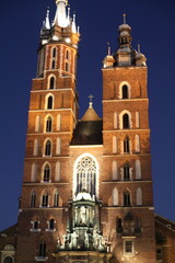 Obraz premium scenic view of city in the evening lights. landscape of the old town street. people like to walk along the historical part of the city.