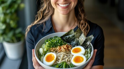 Traditional ramen bowl garnished with eggs, nori, and scallions, captured from an overhead angle