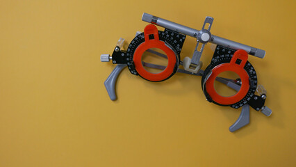 Optometry concept. Trial frame with corrective lenses from lens set. Vision exam for glasses....