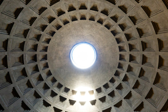 Interior view of Pantheon dome oculus in Rome on a sunny day with sun shining through the hole in the ceiling 