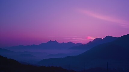Fototapeta premium A beautiful sunset over a range of mountains.