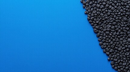 Black background wallpaper gradient and sophisticated, A visually striking image featuring black seeds against a vibrant blue background, creating a bold contrast.