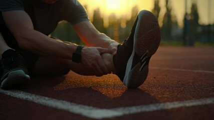 Fitness. Athletic man outdoors purposefully looks after his body on the sports field. Cinematic shot athletic man leads a healthy lifestyle doing a workout, training