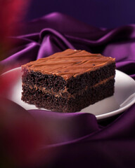 Swiss dark chocolate cake pastry on the purple background
