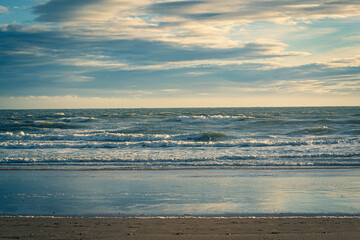 Looking out to the North Sea, with the sun low in the sky casting a golden light over Cruden Bay...