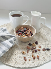 a cup of coffee ,milk and nuts in white background