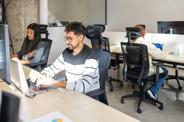 Collaborative workspace showcasing focused teamwork in an office