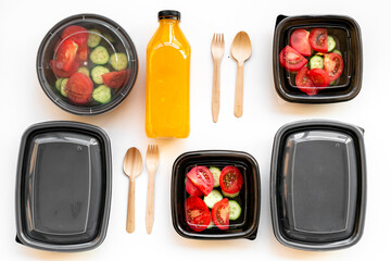 Takeaway food - tomatoes salad in catering boxes, top view. Food delivery concept.