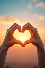 Two hands forming a heart shape, framing a vibrant sunset, symbolizing love and appreciation for nature's beauty.