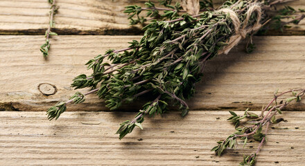 Thyme sprigs on wooden table, top view