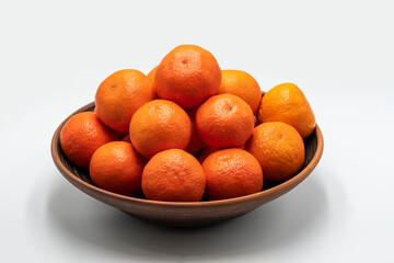 Fresh orange mandarins isolated on white background. A plate of tangerines on a white background. 