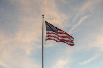 American flag waving at sunset