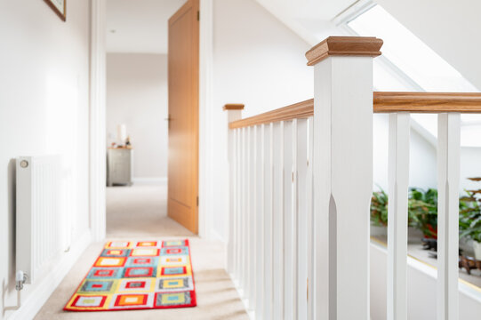 1st floor landing seen on a recently completed loft conversion in a detached bungalow. Skylight windows help produce the bright atmosphere, which leads to a distance bedroom. - Powered by Adobe