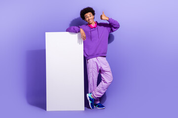 Full size photo of pleasant person wear hoodie showing thumb up nice playlist near smartphone...