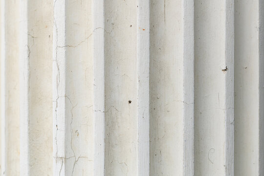 Close-up of textured white concrete column with vertical grooves