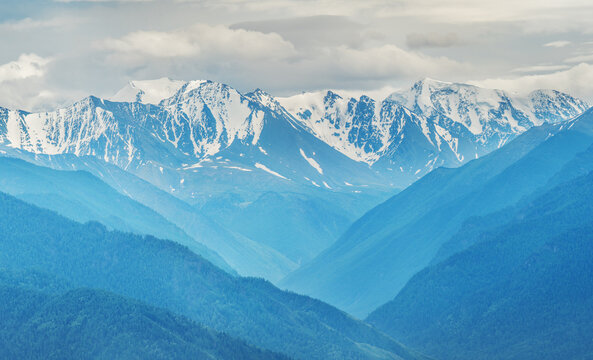 Mountain scenery, snow-capped peaks in the clouds, aerial view