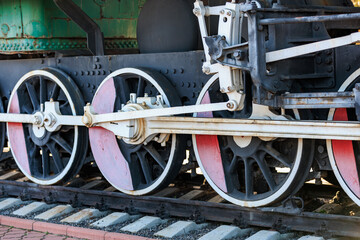 Fototapeta premium Vintage steam train wheels and gears in industrial setting