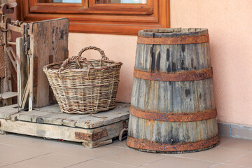 Rustic wooden barrel and braided basket on wooden platform