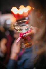 art photo. hand with glass, very soft blurry focus effect. holiday and party atmosphere