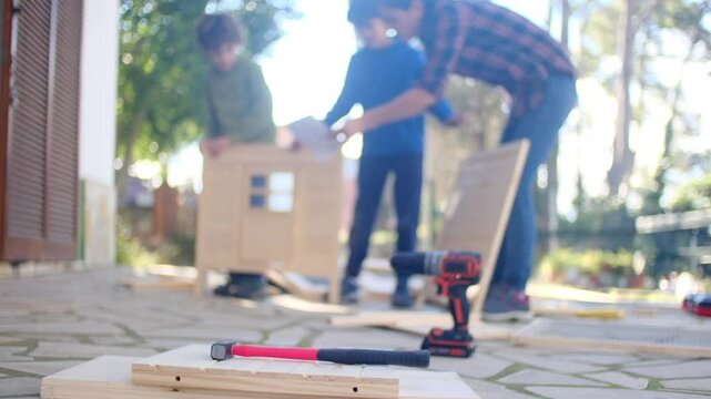 Teamwork, People building a wooden structure together. Concept: teamwork and DIY. Outdoor setting.