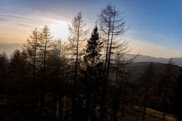The top of the Austrian mountain Gerlitzen in the Carinthian Alps in autumn at sunset with a view of the forest