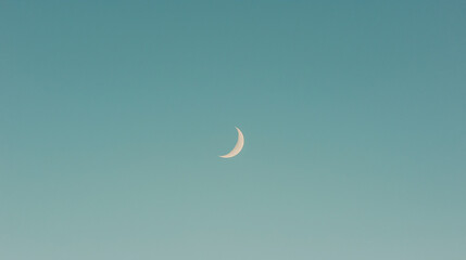 Crescent Moon Serenity:  A crescent moon hangs serenely against a vast, azure sky, casting a peaceful and contemplative ambiance. Its gentle glow evokes a sense of tranquility and quiet contemplation.