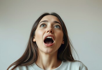 Portrait of a young female yawning with a surprised expression