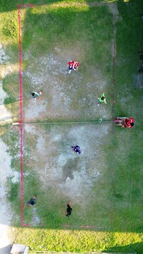 Aerial view of group of young men are playing takraw in the afternoon