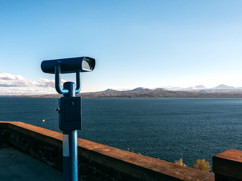 Old coin binocular at Sevanavank Monastery with Lake Sevan view with mountains landscape and blue sky background, Armenia country.