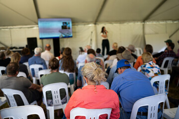 farmers at a field day learning on a farm. learning about agriculture and innovation listen to experts. farming community together in for a growers field day talking to agronomist