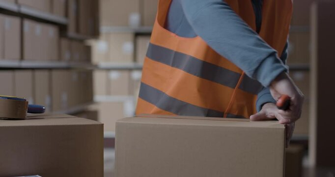 Warehouse operative opening a delivery box