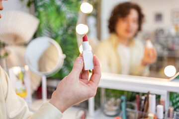 Applying Organic Red Lipstick in Front of Mirror with Makeup Tools