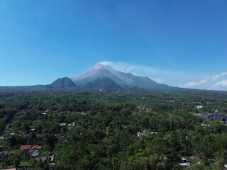Fototapeta premium Aerial drone view of Merapi Mountain in Indonesia under blue sky