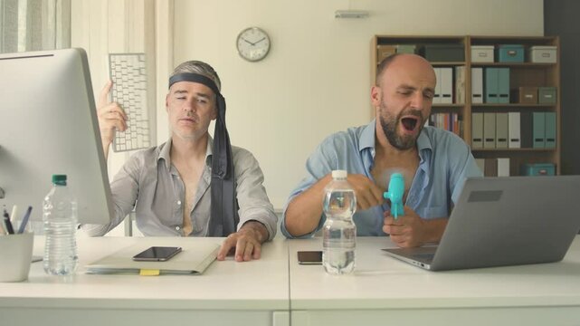 Business people suffering from the heat in the office