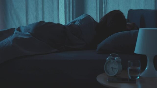 Restless woman in bed at night
